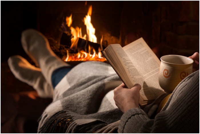 reading a book near a cozy fireplace